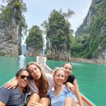 Customers posing in front of the islets in the Cheow Lan Lake in Khao Sok.