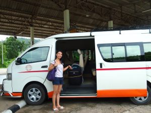 Girl getting into a minivan in Thailand.